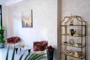 a living room with two chairs and a table at Hotel Cristal in Mamaia Sat/Năvodari