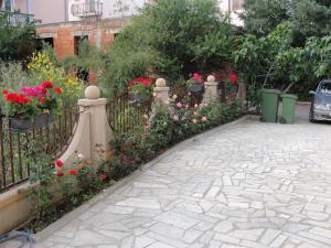 a garden with flowers and a fence at Apartments Lalic in Vodice