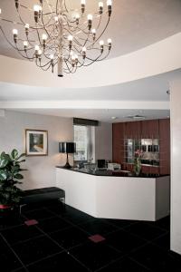 a lobby with a large chandelier in a building at Victoria Hotel in Pescara +25 photos