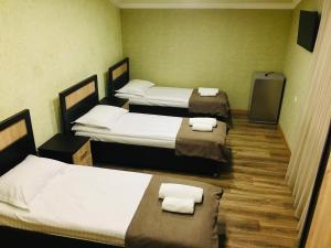 a room with three beds with towels on them at Guesthouse Chambarak in Chambarak +37 photos