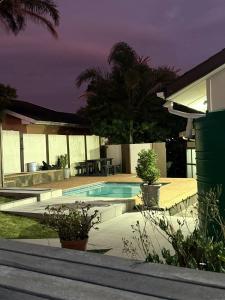 a swimming pool in the backyard of a house at Guest House on Keam in East London