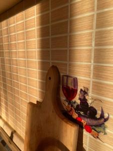 a wooden cutting board with a wine glass on it at TE SHPIA in Baks-Rrjoll +11 photos