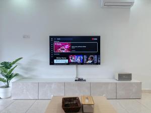 a flat screen tv on a white wall at 10Pax BM大山脚 Alma Single storey Semi-D 5-minute To Aeon Mall in Bukit Mertajam