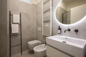 a bathroom with a sink and a toilet and a mirror at TOP CLASS Al Mare in Santa Margherita Ligure +38 photos