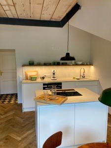 a kitchen with white cabinets and a sink at Loft über Berchtesgaden in Berchtesgaden