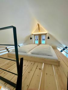 a bed in the attic of a room at Loft über Berchtesgaden in Berchtesgaden