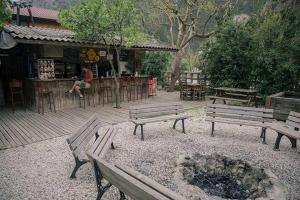 a group of benches sitting in front of a bar at Bayrams Tree Houses in Olympos