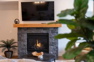 a fireplace with a television on top of it at Modern Mountain Oasis Top floor 2 level 2bd in Canmore +49 photos