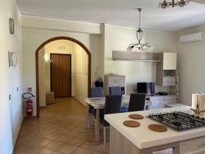 a kitchen and dining room with a table and a stove at Casa Mare Verde in Casamicciola Terme +10 photos
