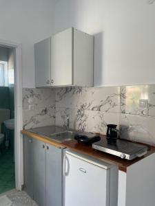 a kitchen with a sink and a counter top at Marina Apartaments in Himare +78 photos