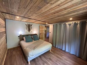 a bedroom with a bed with a skull on the wall at Chalet d'alpage " L'Estive " in Saint-Sorlin-dʼArves
