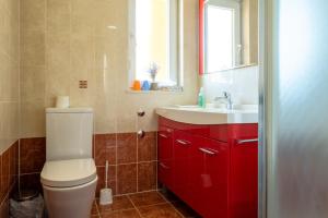 a bathroom with a white toilet and a sink at Yellow house apartments in Podstrana