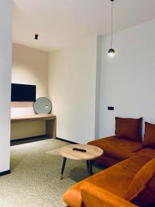 a living room with a couch and a table at Hotel Aeetes Kobuleti in Kobuleti