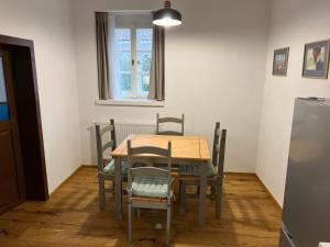 a table and chairs in a room with a window at Na Švestkové trati in Libčeves