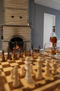 a bottle of wine and a chess board with a bottle of wine at Rent House Dilijan in Dilijan
