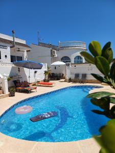 a swimming pool in front of a house at Villa de Lagos Coloridos in Los Montesinos