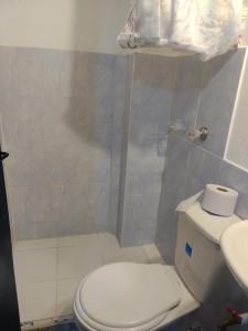 a small bathroom with a toilet and a shower at Abi Happy in Villa de Leyva +6 photos