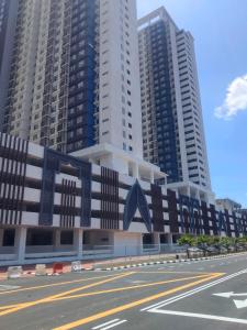 a city street with tall buildings in the background at Dhia Homestay Sireh Residence Near Aeon Mall in Kota Bharu