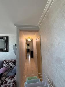 a room with a hallway with a couch and a stairway at Appartement FNIDEQ BAB CEUTA in Fnidek