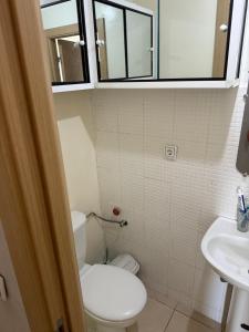 a small bathroom with a toilet and a sink at Appartement FNIDEQ BAB CEUTA in Fnidek