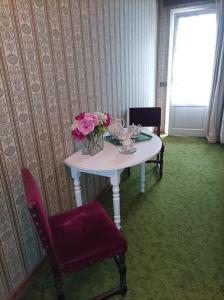 a table with a vase of flowers on it at Suite in The Calm Nature of Prosecco Valley in Revine Lago +3 photos