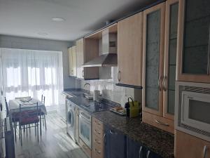 A kitchen or kitchenette at Apartamentos El Conde