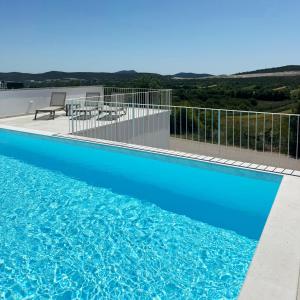 a blue swimming pool with a view of the ocean at Villa Velim - Stunning view & Heated private pool in Stankovci