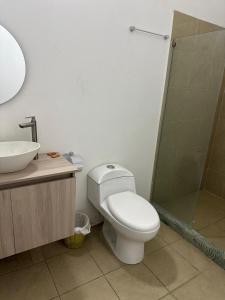 a bathroom with a toilet and a sink and a shower at SGH Hotel San Agustin in Santa Marta +11 photos