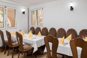 a dining room with a table and chairs at Vila Midami - Herceg Novi Savina in Herceg-Novi +9 photos