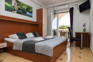 a hotel room with a bed and a balcony at Vila Midami - Herceg Novi Savina in Herceg-Novi