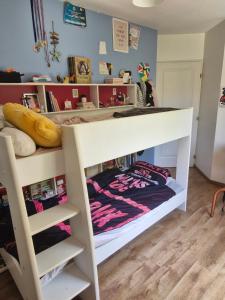 a bunk bed in a childs bedroom at Notre petit coin de paradis in Saint-Germain-du-Bel-Air +5 photos