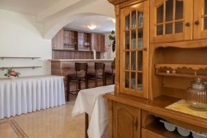 a kitchen with a table and chairs in a room at Vila Midami - Herceg Novi Savina in Herceg-Novi