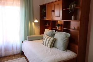 a couch with two pillows on it in a room at Terras da Planície in Ferreira do Alentejo +6 photos
