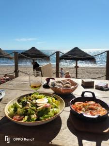 a table with a salad and a glass of wine at Finca Corazonada in Ríogordo