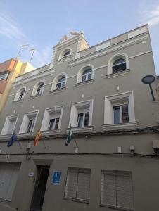a large building with windows and kites hanging from it at Patio Cuarenta 2B in Algeciras +3 photos