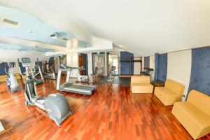 a gym with treadmills and exercise equipment in a room at Victoria Hotel in Pescara