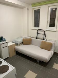 a living room with a white couch in a kitchen at Your home 9 with parking in Myslava