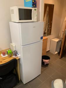 a microwave sitting on top of a white refrigerator at Your home 9 with parking in Myslava +2 photos