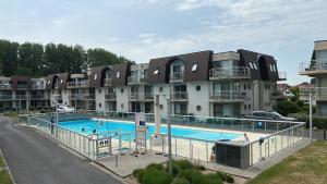 a large swimming pool in front of a building at Blutsyde promenade Biaritz 0108 in Bredene