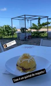 a piece of cake on a plate on a table at Flat aconchegante em Recife in Recife
