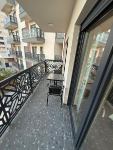 a balcony of a building with a bench on it at Riga's Apartment in Prizren