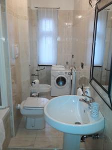 y baño con lavabo y lavadora. en Residence Sole, en Trieste