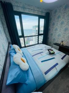 a bedroom with a bed with two stuffed animals on it at The base Central Pattaya 271 by Numam in Pattaya +57 photos