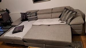 a couch with pillows on it in a living room at Apartman NAR Murter in Murter +27 photos