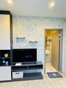 a living room with a flat screen tv on a wall at The base Central Pattaya 271 by Numam in Pattaya