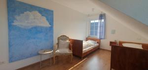 a bedroom with a bed and a painting of a cloud at Ferienwohnung Luft und Erde in Celle
