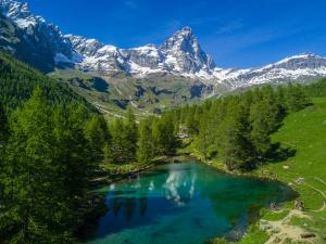 an aerial view of a lake with mountains in the background at Cervinia Ski Apartment François - Private Hot Tub & Mountain View in Breuil-Cervinia