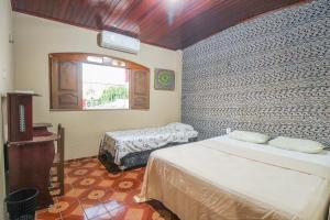 Postel nebo postele na pokoji v ubytování Hostel Roraima