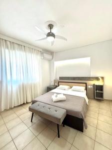 a bedroom with a bed and a ceiling fan at Central appartment 2 with parking in Larisa