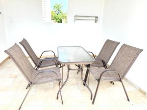 a group of chairs and a table in a room at Sakellis Home 2- Steps to Beach & Town in Kardamaina
